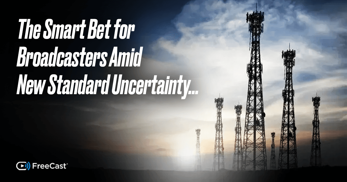 Tall broadcast transmission towers stand silhouetted against a dramatic sunset sky, symbolizing the shifting landscape of TV broadcasting and digital standards. The image includes the headline “The Smart Bet for Broadcasters Amid New Standard Uncertainty…” and a small FreeCast logo in the corner.